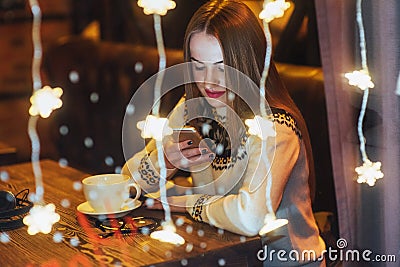 Young beautiful woman sitting in cafe, drinking coffee. Christmas, new year, Valentines day, winter holidays concept Stock Photo