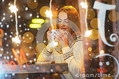 Young beautiful woman sitting in cafe, drinking coffee. Christmas, new year, Valentines day, winter holidays concept Stock Photo