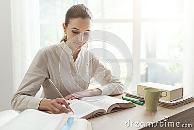 Young woman studying at home Stock Photo