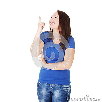 Young beautiful woman is smiling and pointing up. Stock Photo