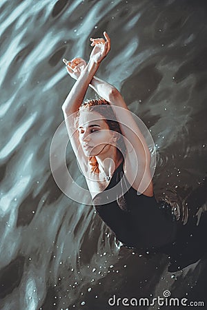 Young beautiful woman standing in the water. Stock Photo