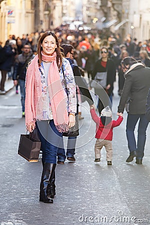 Young beautiful woman stands in a crowd of citizens Editorial Stock Photo