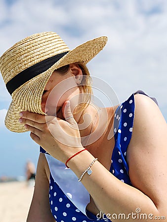 Shy hat at the beach Stock Photo