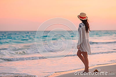 Young beautiful woman on tropical beach in sunset. Stock Photo