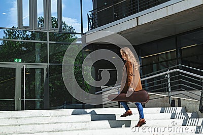 Woman with violin in case goes to lesson on stairs Stock Photo