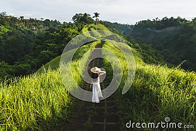 Woman walking on Campuhan Ridge way Bali, Ubud in morning Stock Photo