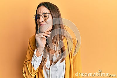 Young beautiful woman wearing business style and glasses touching painful neck, sore throat for flu, clod and infection Stock Photo