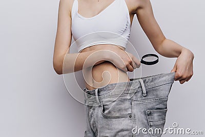 Young beautiful woman on white background lost weight, diet, fitness, sports Stock Photo