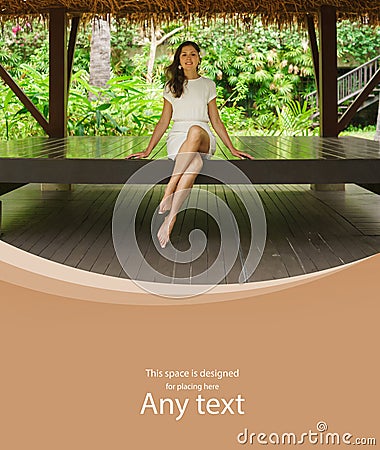 Young and beautiful woman in white dress. Woman posing in exotic Thai bungalow. Resting and traveling concept. Stock Photo