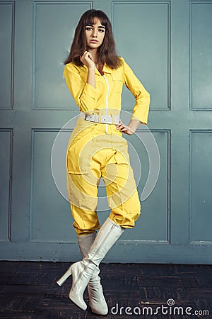 Young beautiful woman in yellow work suit Stock Photo