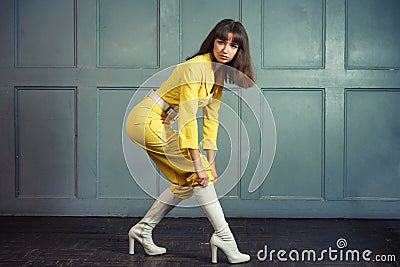 Young beautiful woman in yellow work suit Stock Photo