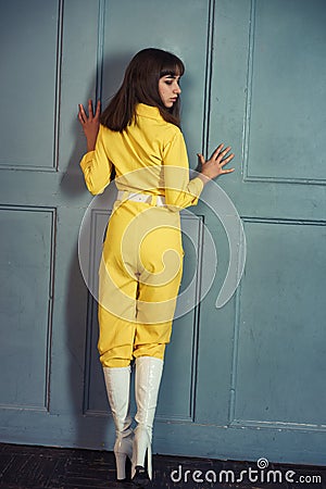 Young beautiful woman in yellow work suit Stock Photo