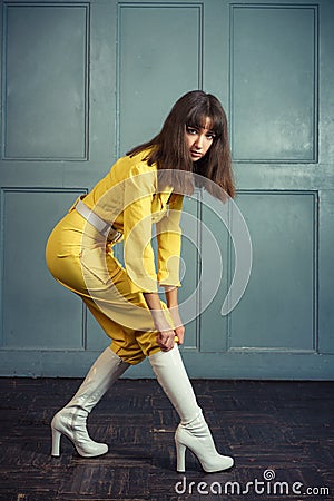 Young beautiful woman in yellow work suit Stock Photo