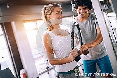 Young beautiful woman doing exercises with personal trainer Stock Photo