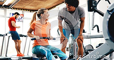 Young beautiful woman doing exercises with personal trainer Stock Photo