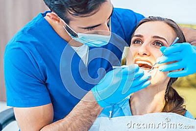 Beautiful woman looking with confidence at her reliable dentist Stock Photo