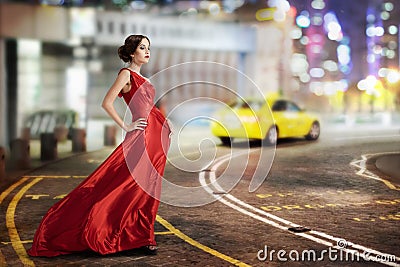 Young Beauty Famous Woman In Fluttering Red Dress Outdoor Stock Photo