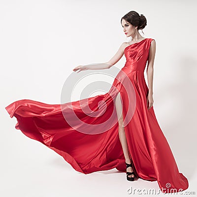 Young beauty woman in fluttering red dress. White background. Stock Photo