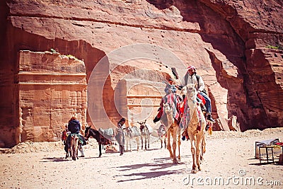 Young Bedouin and boy Bedouin are riding camels Editorial Stock Photo