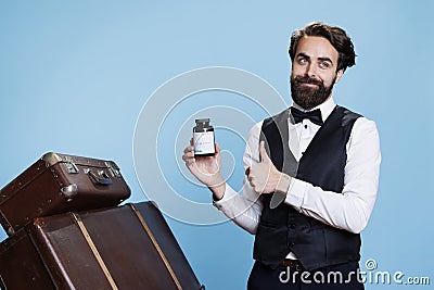 Young bellman holds bottle of drugs Stock Photo
