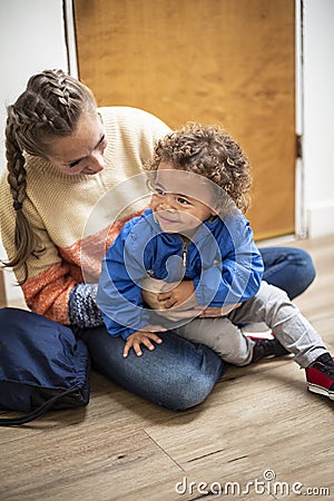 Young bi-racial child being watched by a babysitter Stock Photo