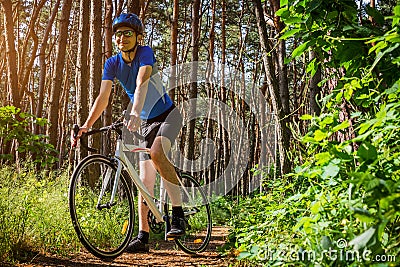 Young bicyclist riding in the forest Stock Photo