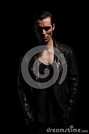Young biker in black leather posing with hands in pockets Stock Photo