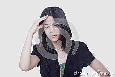 Young biracial teen girl massaging temple, stressed, Stock Photo