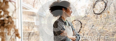 Young black ceramist woman smiling while working in her studio Stock Photo