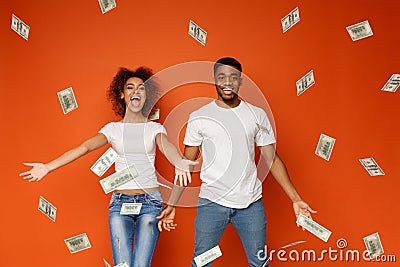 Young black couple enjoying money banknotes shower Stock Photo