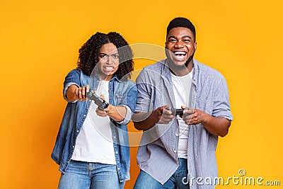 Young black couple with joysticks competing in video games with each other Stock Photo