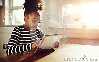 Young black girl browsing on a tablet-pc Stock Photo