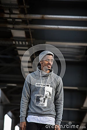 A young, black hipster poses for a candid photograph in NYC Editorial Stock Photo