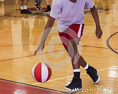 Dribbling a basketball indoors Stock Photo