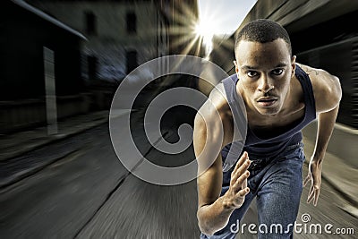 Young black male running in an urban setting Stock Photo