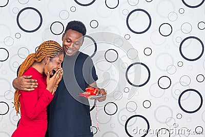 Young black man surprises a lady with a cash gift Stock Photo