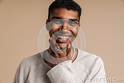 Young black man wearing rings laughing while looking at camera Stock Photo