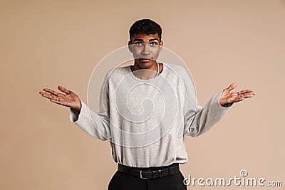 Young black man wearing rings looking and gesturing at camera Stock Photo