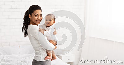 Young Black Mom Holding Baby Toddler Posing Standing Indoors, Panorama Stock Photo