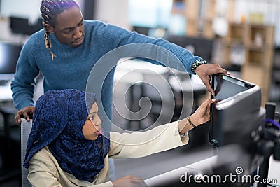 Young black muslim female software developer at work Stock Photo