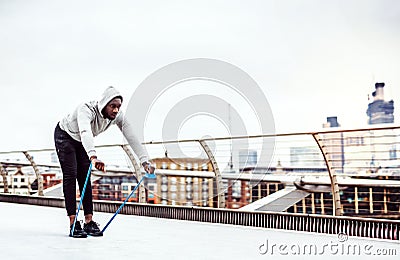 Young black sportsman exercising with elastic rubber bands in London. Stock Photo
