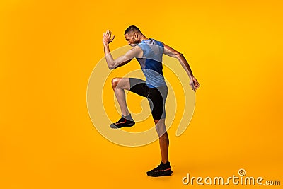 Young black sportsman walks highly lifting knees Stock Photo