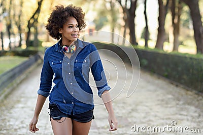 Young black woman with afro hairstyle standing in urban background Stock Photo