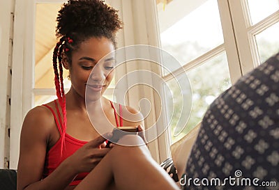 Young Black Woman Reading Phone Message And Smiling Stock Photo