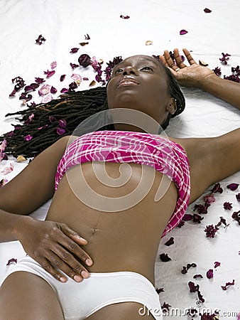 Young black woman in white panties on floor Stock Photo