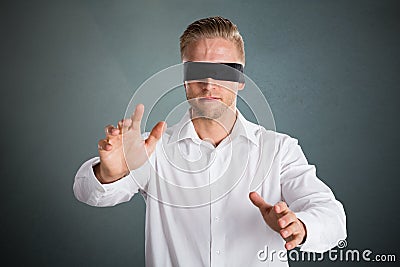 Young Blindfolded Businessman Stock Photo