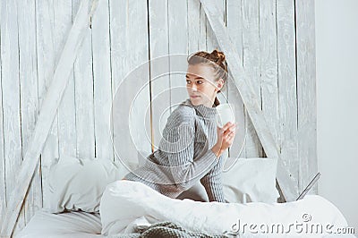 Young blogger or business woman working at home with social media, drinking coffee in early morning in bed Stock Photo