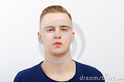 Young blond handsome man in blue shirt poses Stock Photo