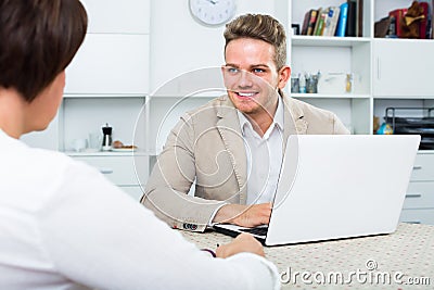 Young blond man and businesswoman communicate Stock Photo