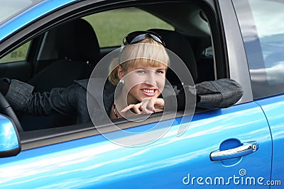 Young blond woman in a car. Stock Photo